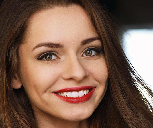 Beautiful dental patient showing new crowns